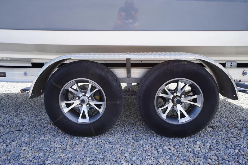 Slide: The Image of Trailer wheels of a 2020 Tidewater 220 LXF boat on gravel surface. - 41