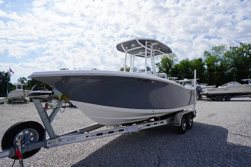 Slide: The Image of 2020 Tidewater 220 LXF boat on trailer under a partly cloudy sky. - 44