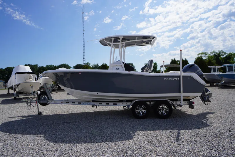 Slide: The Image of 2020 Tidewater 220 LXF boat on trailer under blue sky. - 45