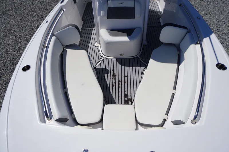 Slide: The Image of 2020 Tidewater 220 LXF boat interior with white seating and gray flooring. - 7