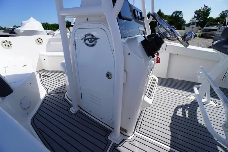 Slide: The Image of 2020 Tidewater 220 LXF boat interior with steering console and seating area. - 9