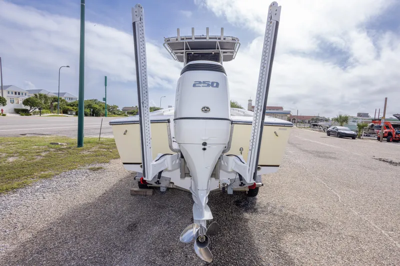 Slide: The Image of 2004 Sea Craft 23 CC boat with powerful outboard motor, parked on a sunny day. - 13