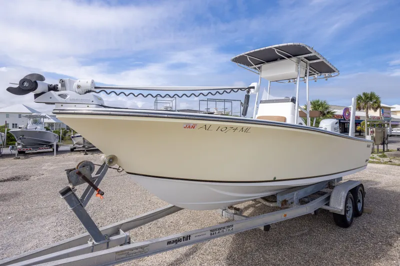 Slide: The Image of 2004 Sea Craft 23 CC boat on trailer, parked outdoors under a clear sky. - 15