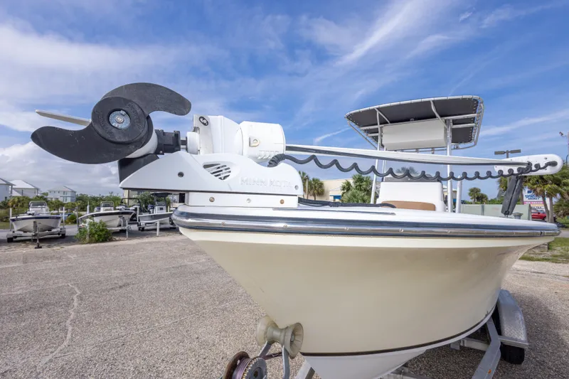 Slide: The Image of 2004 Sea Craft 23 CC boat with trolling motor, parked on a trailer. - 16