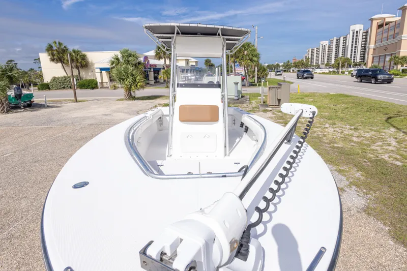 Slide: The Image of 2004 Sea Craft 23 CC boat parked near a road with palm trees and buildings. - 17