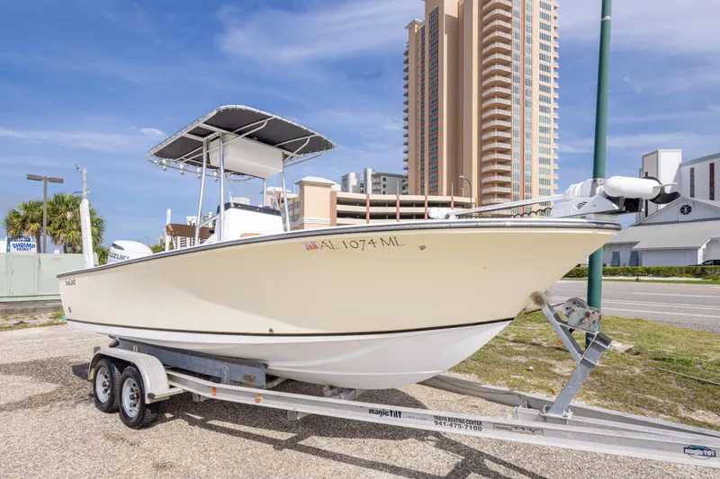 Slide: The Image of 2004 Sea Craft 23 CC boat on trailer, urban background, clear sky. - 2