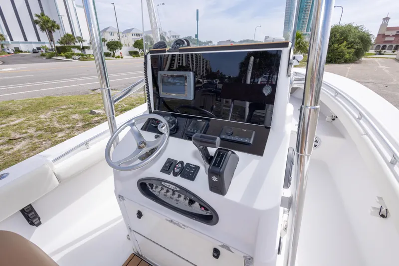Slide: The Image of Center console of a 2004 Sea Craft 23 CC boat with steering wheel and controls. - 21