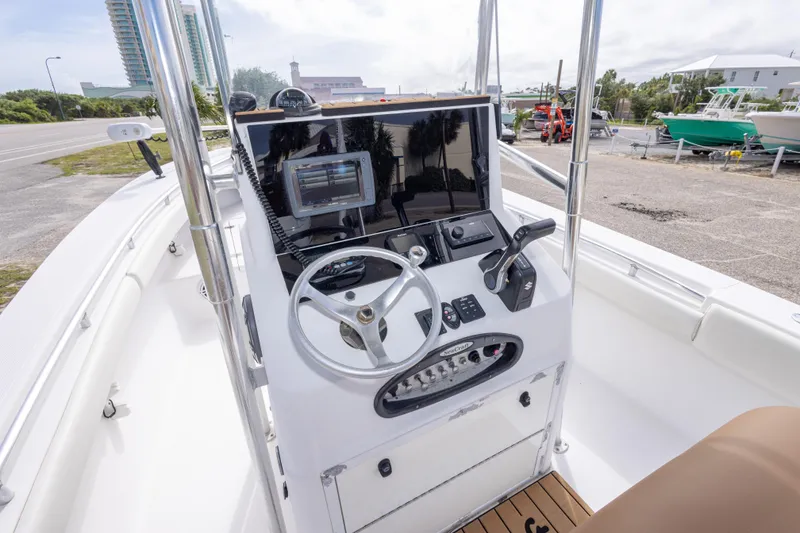 Slide: The Image of 2004 Sea Craft 23 CC boat console with steering wheel and navigation equipment. - 22