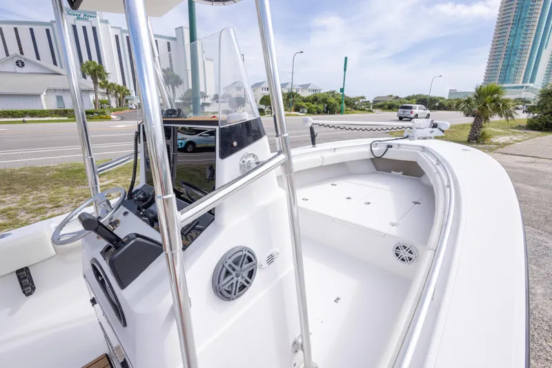 Slide: The Image of 2004 Sea Craft 23 CC boat with sleek white interior and modern controls. - 23