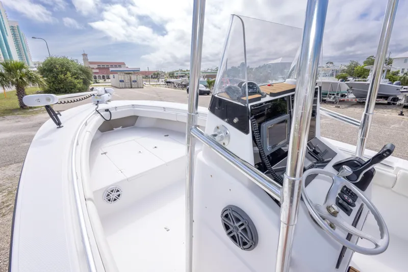Slide: The Image of 2004 Sea Craft 23 CC boat with modern console and spacious deck, docked outdoors. - 25
