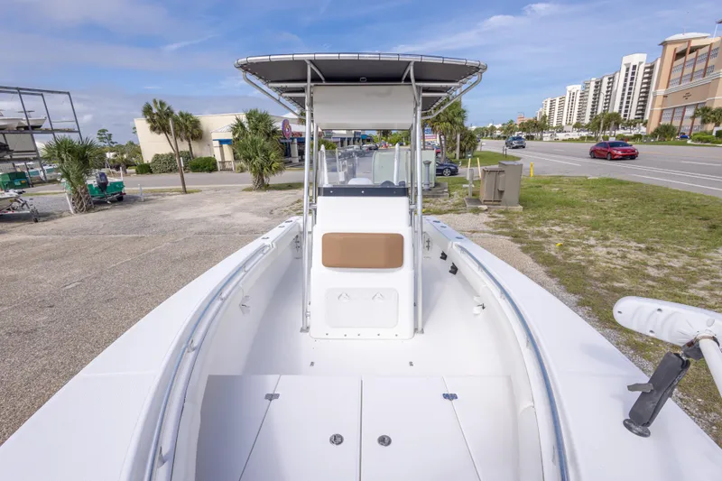 Slide: The Image of 2004 Sea Craft 23 CC boat with center console, parked near a road and buildings. - 29