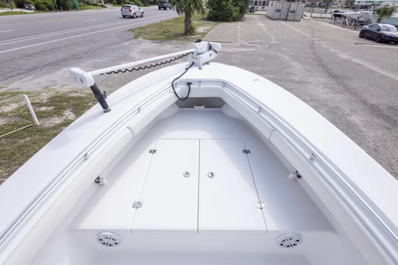 Slide: The Image of 2004 Sea Craft 23 CC boat deck with storage compartments and railing, parked near a road. - 30