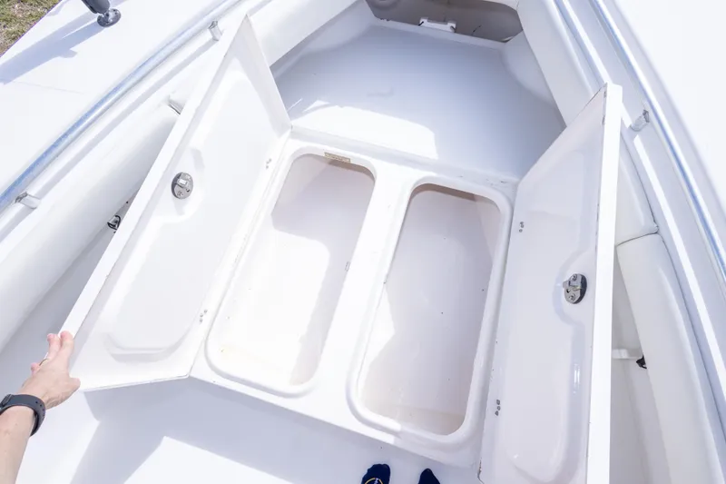 Slide: The Image of Open storage compartments on a 2004 Sea Craft 23 CC boat deck. - 31