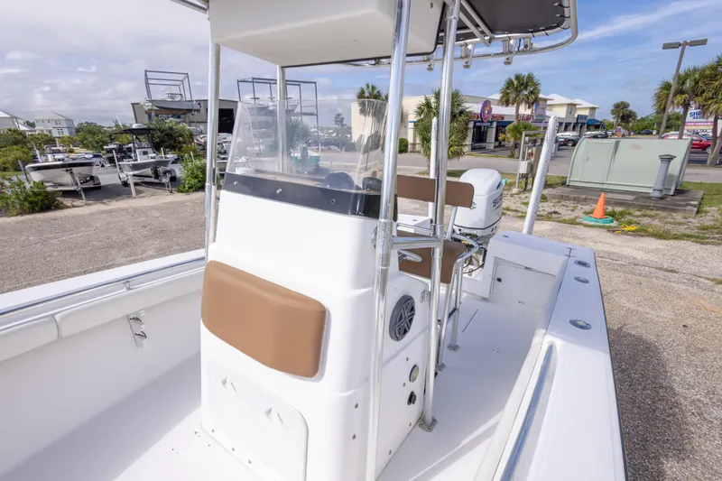 Slide: The Image of 2004 Sea Craft 23 CC boat with center console and seating, parked outdoors. - 32