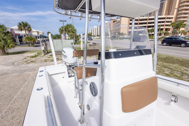 Slide: The Image of 2004 Sea Craft 23 CC boat with Suzuki outboard motor, parked near a road. - 33