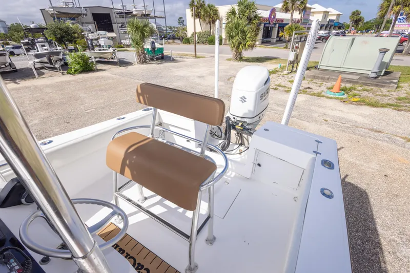 Slide: The Image of 2004 Sea Craft 23 CC boat with Suzuki outboard motor, parked outdoors. - 35