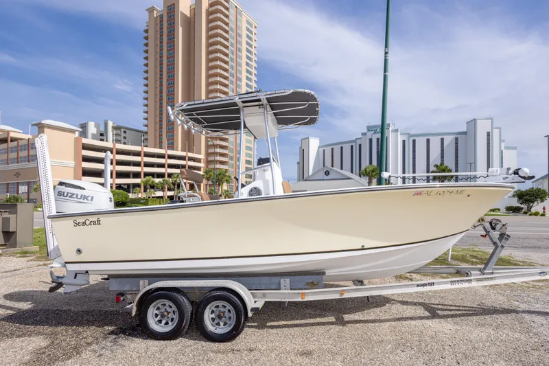 Slide: The Image of 2004 Sea Craft 23 CC boat on trailer, urban background, clear sky. - 9