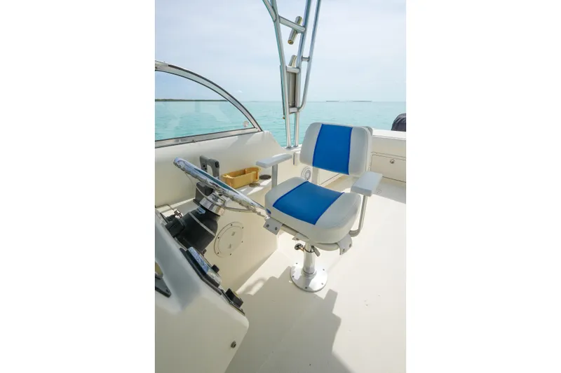 Slide: The Image of Captain's chair on 2006 World Cat 250 DC boat, overlooking serene ocean waters. - 13