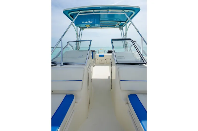 Slide: The Image of 2006 World Cat 250 DC boat interior with blue accents and open deck view. - 14