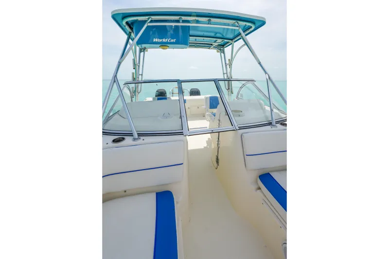 Slide: The Image of 2006 World Cat 250 DC boat interior with blue accents and open deck view. - 16
