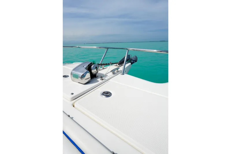 Slide: The Image of Bow of 2006 World Cat 250 DC boat with anchor, on turquoise water. - 17