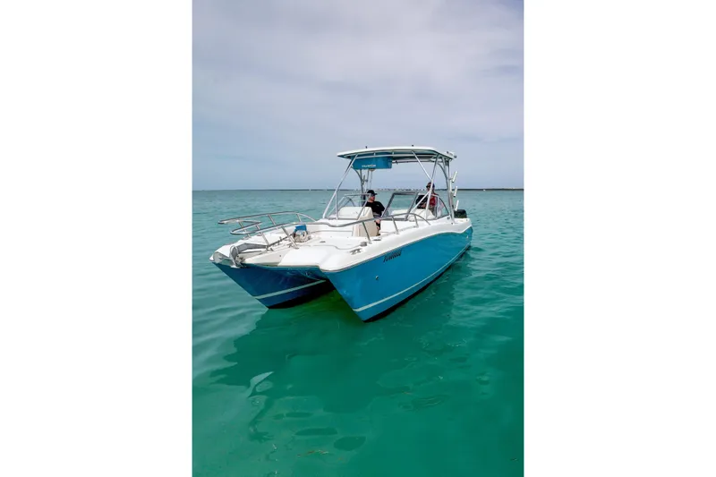 Slide: The Image of 2006 World Cat 250 DC boat on clear turquoise water. - 2
