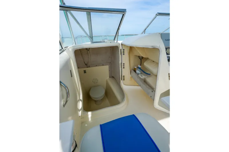 Slide: The Image of 2006 World Cat 250 DC boat interior with toilet and storage compartments. - 24