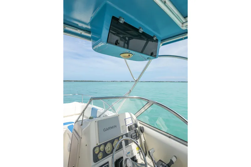 Slide: The Image of Helm of 2006 World Cat 250 DC boat with Garmin navigation system on turquoise waters. - 26
