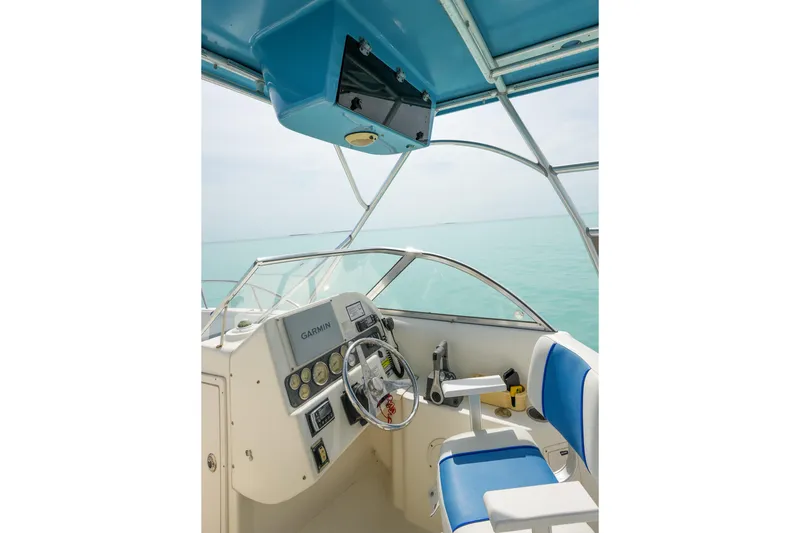 Slide: The Image of Interior view of 2006 World Cat 250 DC boat cockpit with steering wheel and controls. - 28
