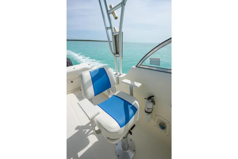 Slide: The Image of Captain's chair on 2006 World Cat 250 DC boat, overlooking turquoise ocean waters. - 30