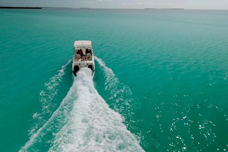 Slide: The Image of Boat cruising on turquoise waters, World Cat 250 DC, 2006 model. - 31