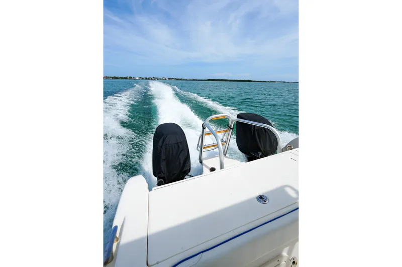 Slide: The Image of World Cat 250 DC boat cruising on open water, leaving a wake behind. - 6