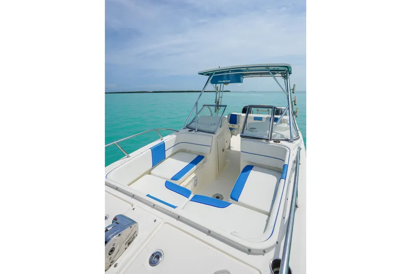 Slide: The Image of 2006 World Cat 250 DC boat interior with blue and white seating on turquoise water. - 7