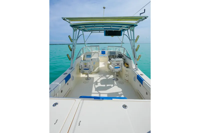 Slide: The Image of 2006 World Cat 250 DC boat interior with dual consoles on turquoise water. - 8