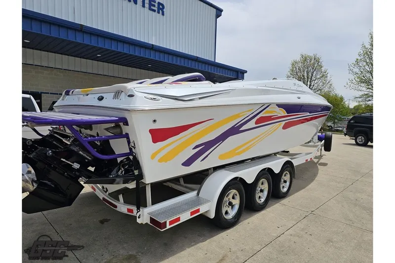Slide: The Image of 2005 Baja 30 Outlaw speedboat with colorful graphics on a trailer. - 11