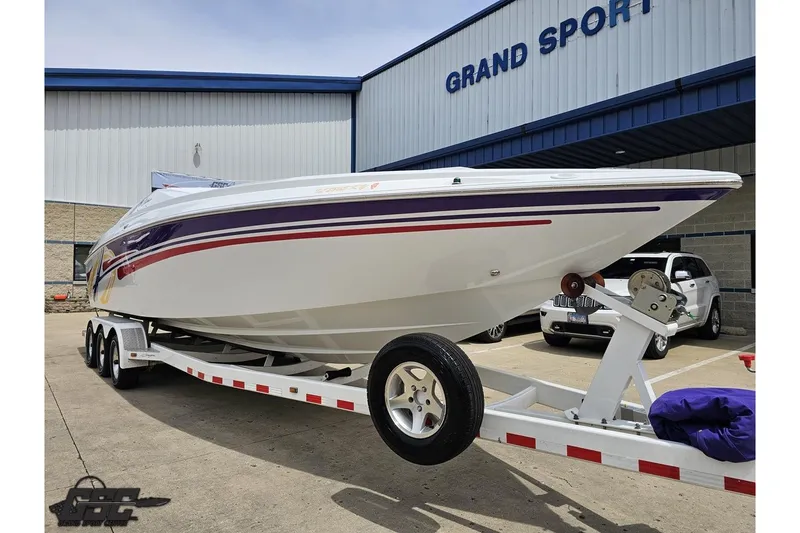 Slide: The Image of 2005 Baja 30 Outlaw boat on trailer outside Grand Sport building. - 15