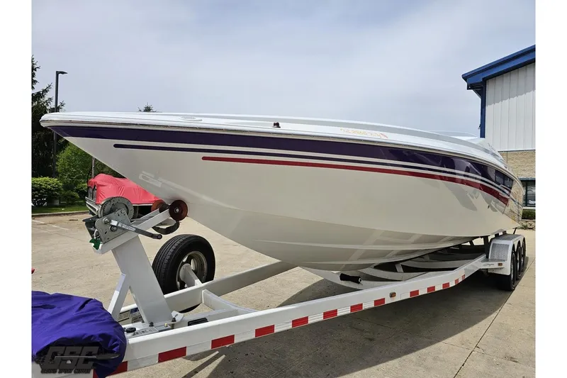 Slide: The Image of 2005 Baja 30 Outlaw boat on trailer, white with red and purple accents. - 18
