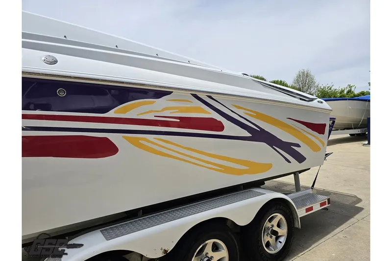 Slide: The Image of 2005 Baja 30 Outlaw boat with colorful graphics on a trailer. - 21
