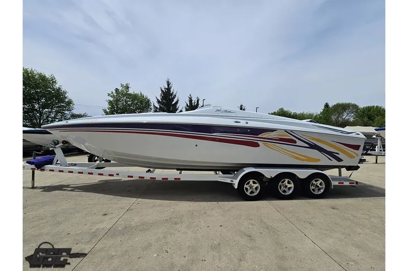 Slide: The Image of 2005 Baja 30 Outlaw speedboat on trailer, featuring vibrant graphics and sleek design. - 23