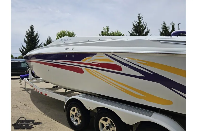 Slide: The Image of 2005 Baja 30 Outlaw boat with colorful graphics on a trailer. - 25