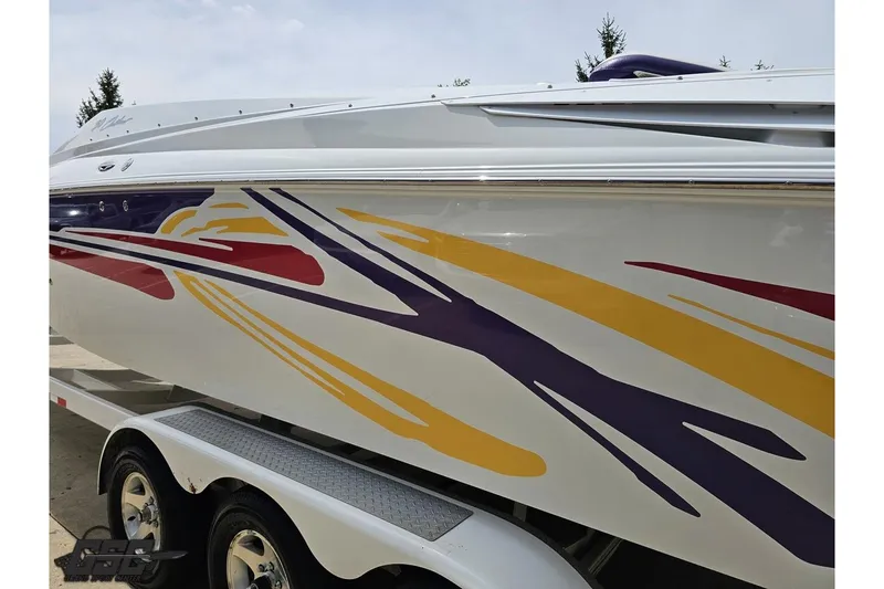Slide: The Image of 2005 Baja 30 Outlaw boat with vibrant, colorful graphics on the side. - 26