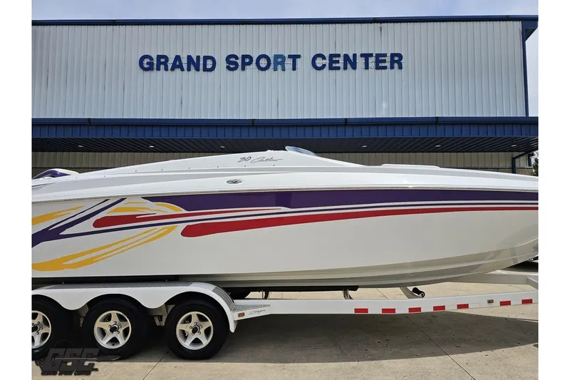 Slide: The Image of 2005 Baja 30 Outlaw boat with colorful graphics at Grand Sport Center. - 3