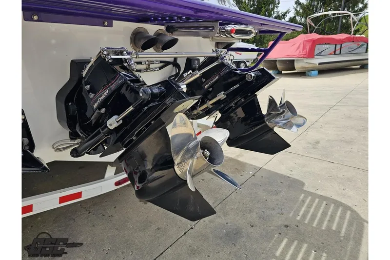 Slide: The Image of 2005 Baja 30 Outlaw boat with dual MerCruiser outdrives and polished propellers. - 32