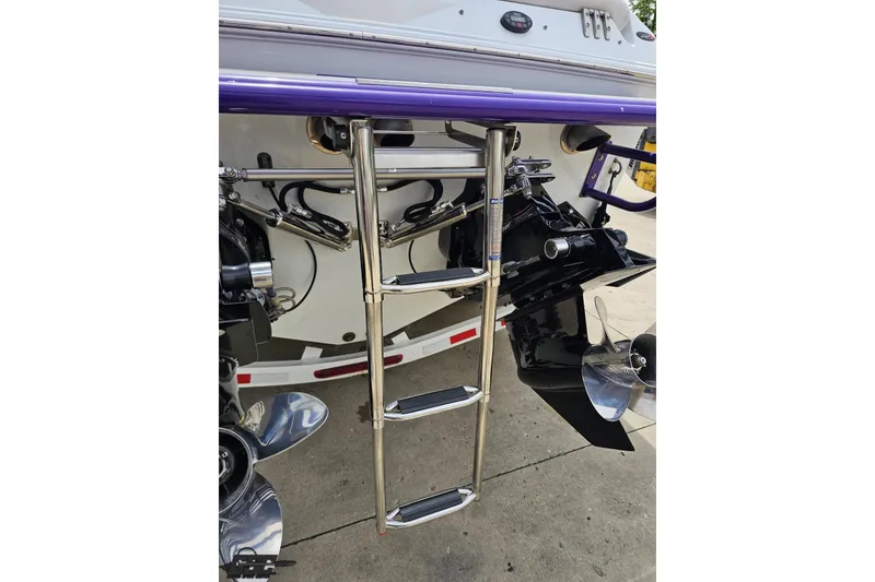 Slide: The Image of Rear view of a 2005 Baja 30 Outlaw boat with stainless steel ladder and propellers. - 34