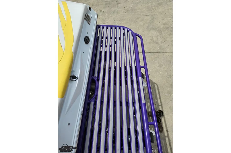 Slide: The Image of 2005 Baja 30 Outlaw boat with yellow accents and purple railing. - 35