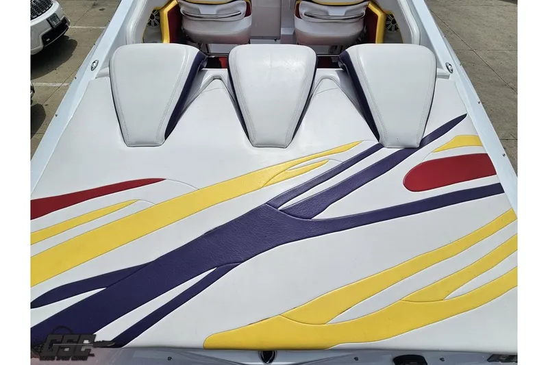 Slide: The Image of 2005 Baja 30 Outlaw boat with vibrant yellow, red, and purple upholstery design. - 37