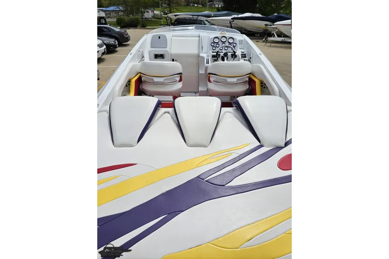 Slide: The Image of 2005 Baja 30 Outlaw boat interior with colorful upholstery and dual seating. - 38