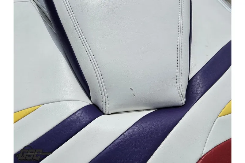 Slide: The Image of White and purple leather seat detail of a 2005 Baja 30 Outlaw boat. - 42