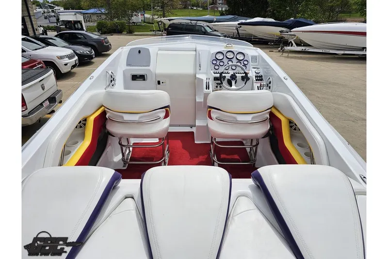 Slide: The Image of 2005 Baja 30 Outlaw boat interior with white seating and vibrant red accents. - 43