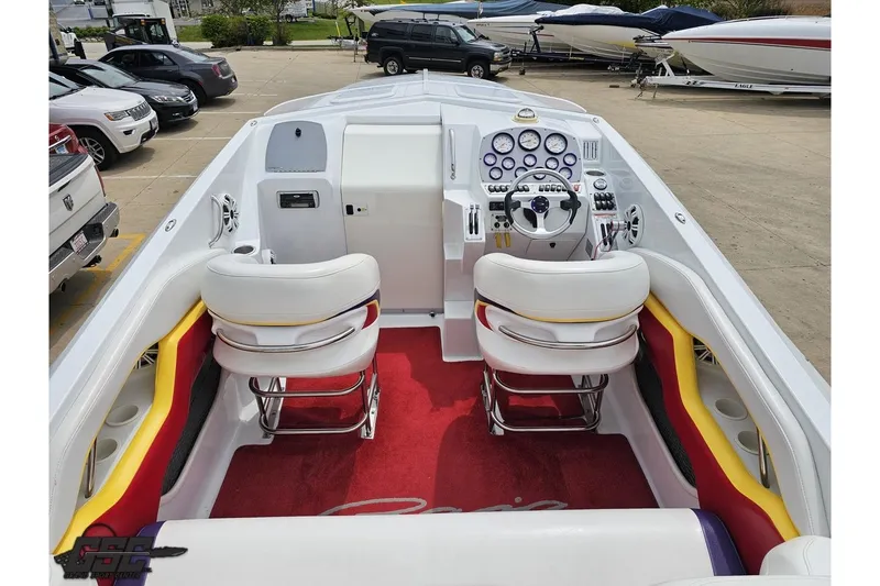 Slide: The Image of 2005 Baja 30 Outlaw boat interior with white seats, red carpet, and control dashboard. - 44